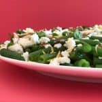 Close up of green bean salad with toasted almonds and feta