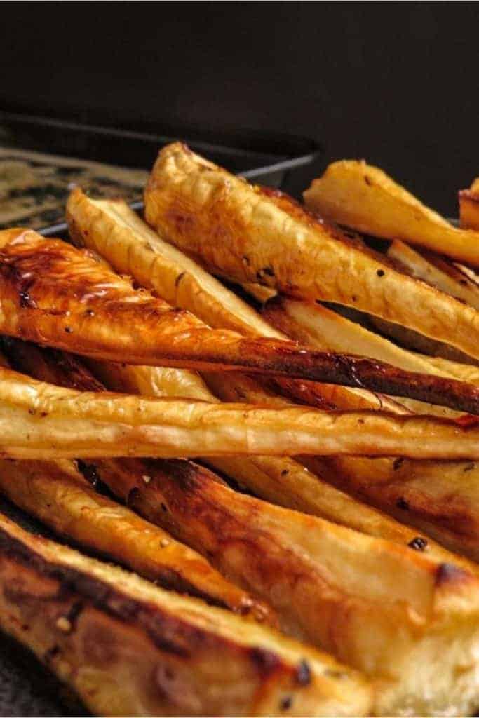 side on view of tray of maple roasted parsnips