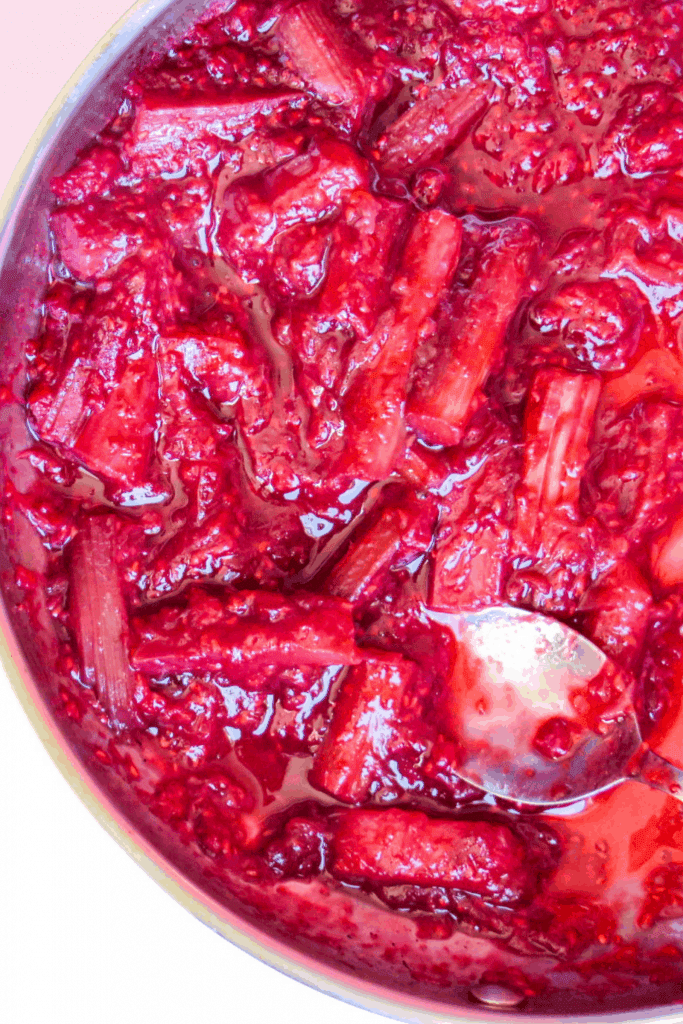 close up of stewed rhubarb and raspberries in a pan