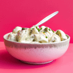 bowl of Greek Yogurt Potato Salad on pink background