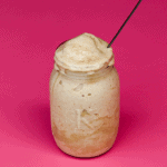 glass with frappe on pink background