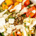 A grain bowl with buckwheat, roast veggies, feta, pumpkin seeds and tahini drizzle.