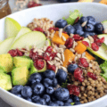 Lentil and rice grain bowl with apple, blueberries, pumpkin, avocado, dried cranberries and sunflower seeds.