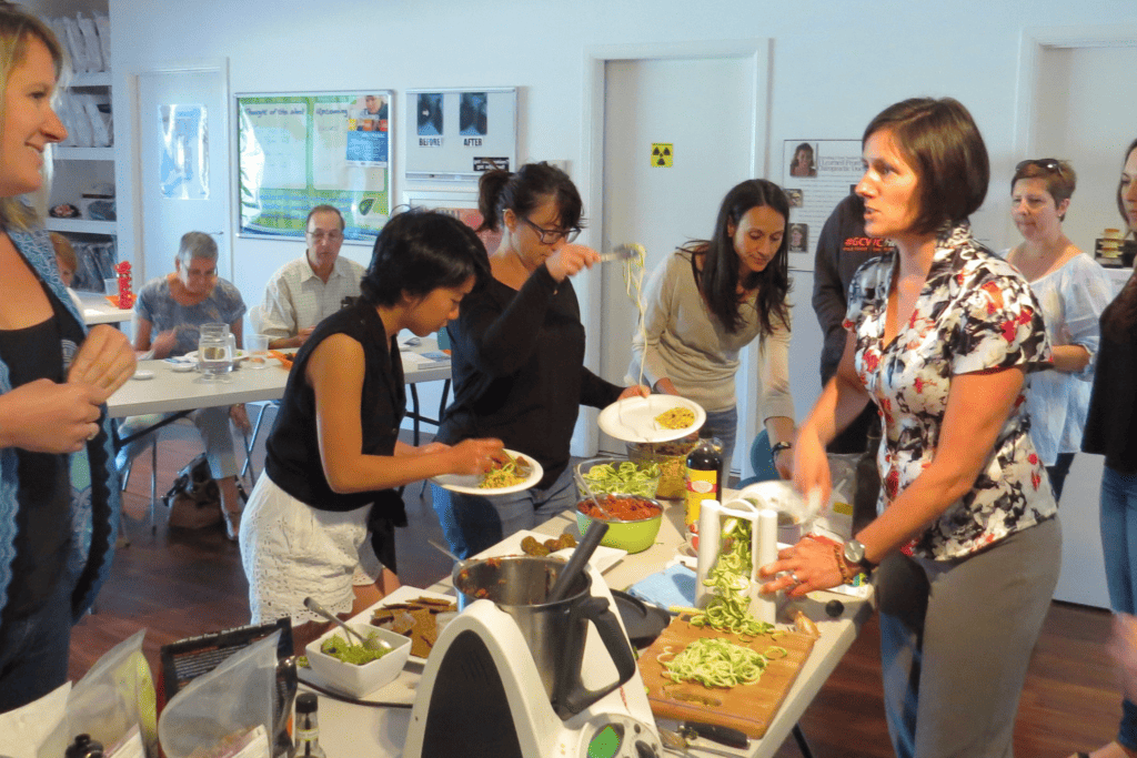 Tansy Boggon demonstrating spiralizing zucchini noodles at a raw food workshop